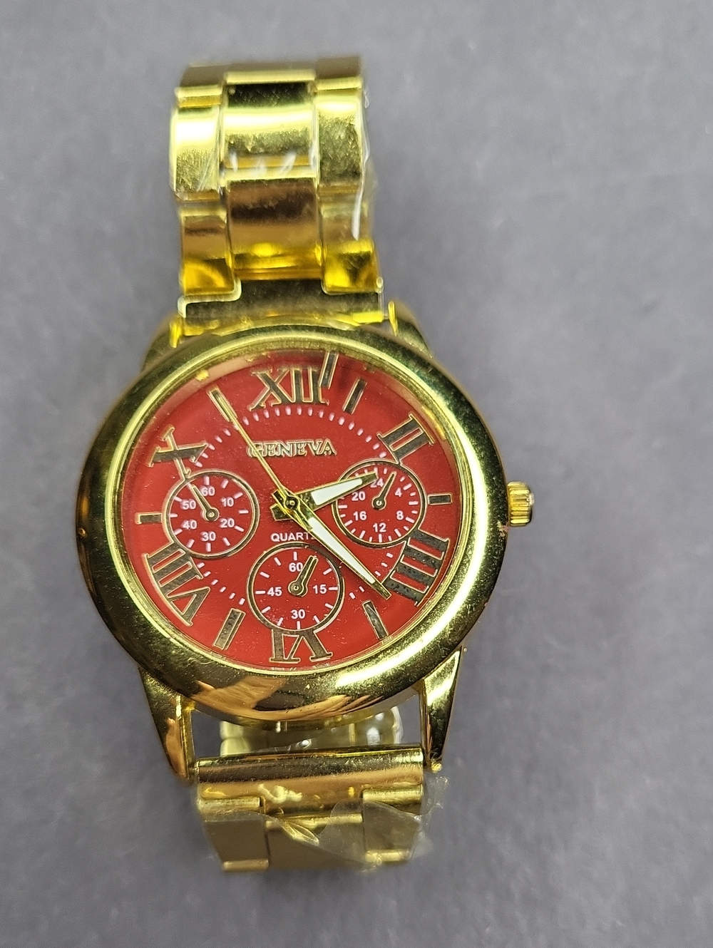 Geneva Gold Tone Watch with Red Dial